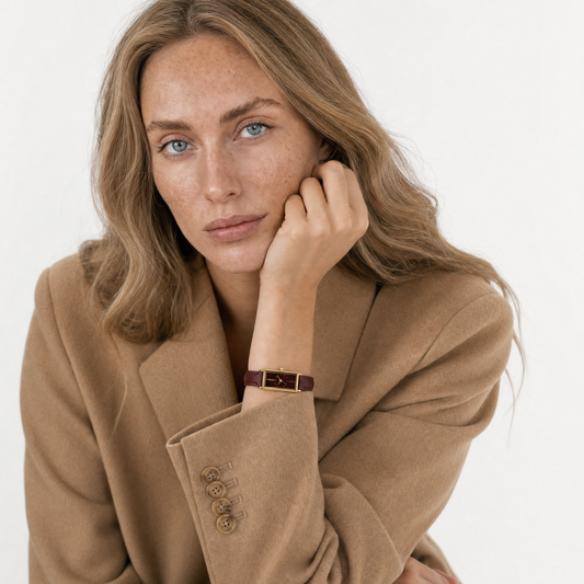 Montaigne Watch Burgundy women's watch on model wrist, worn with a camel coat