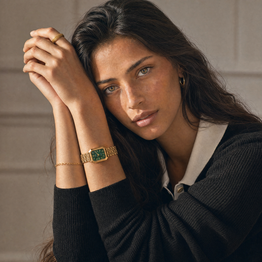 Le Marais Watch Forest green dial watch on model wrist, portrait with hands crossed under chin, black knit top