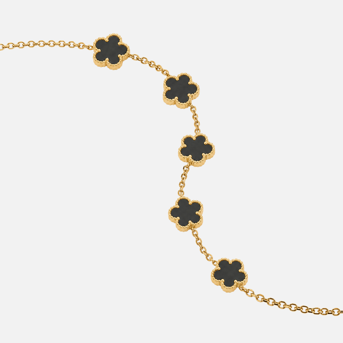 Trèfle Bracelet Gold & Onyx close-up of black five-leaf clover charms with beaded gold tone edges