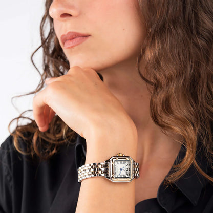 Marceau Watch Aurore two-tone watch on model wrist, hand resting under chin, close-up lifestyle shot