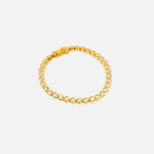 Cassiopeia Tennis Bracelet by Vaurie Paris, gold tone bracelet with round bezel-set clear stones, flat lay