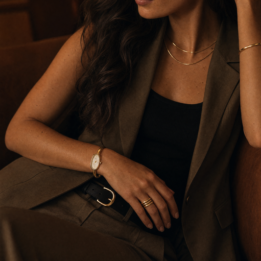 Passy Watch Gold on model wrist in a moody lifestyle shot with an olive suit
